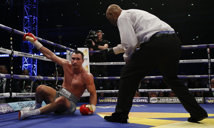 Wladimir Klitschko receives a count by the referee after being knocked down by Anthony Joshua